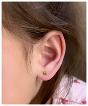 Toddler wearing the 24K 4mm Ball studs