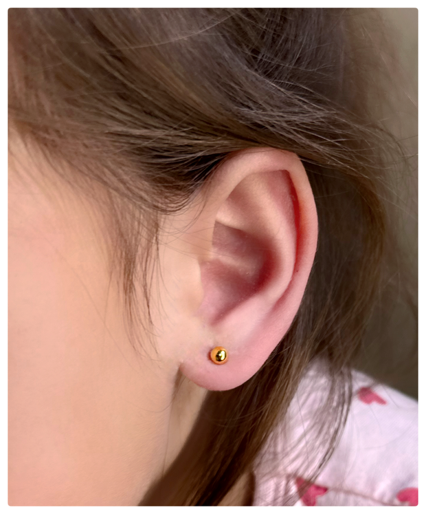 Toddler wearing the 24K 4mm Ball studs