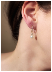 Pearl earrings on a models ear