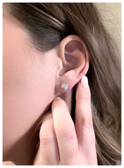 Model is wearing the 18K white gold art deco earrings on her ear