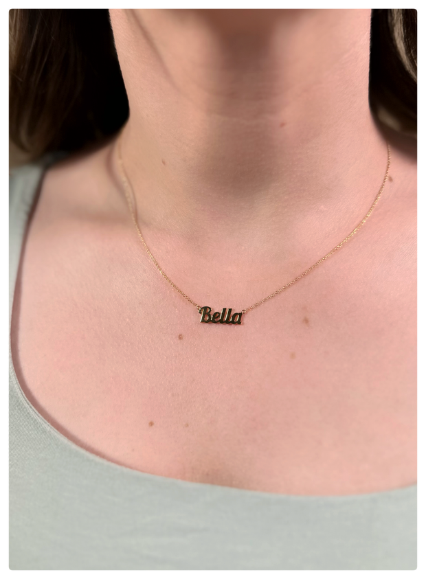 Model is wearing a Bella name plate font necklace