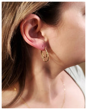 Model is wearing the double loop earrings on her ear