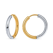 Pair of two-toned silver and gold hoop earrings on a white background