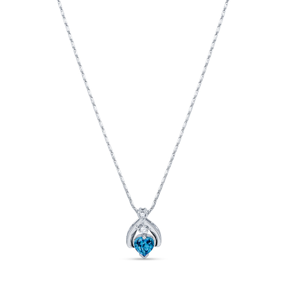 Silver pendant necklace with a heart shaped blue topaz gemstone on a white background.