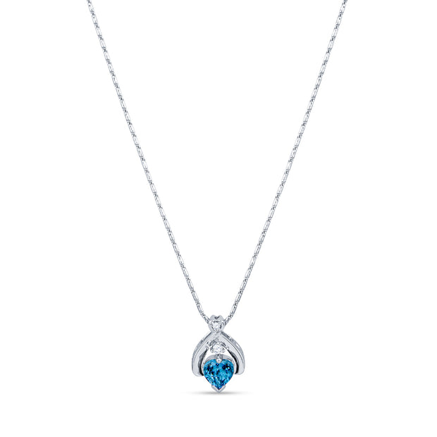 Silver pendant necklace with a heart shaped blue topaz gemstone on a white background.