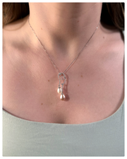 Model wearing the Jasmine double pearl pendant with a white gold chain around her neck. 