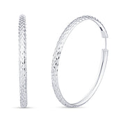 Pair of white gold hoop earrings with a hammered texture on a plain white background.