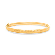 18K yellow bangle on a white background