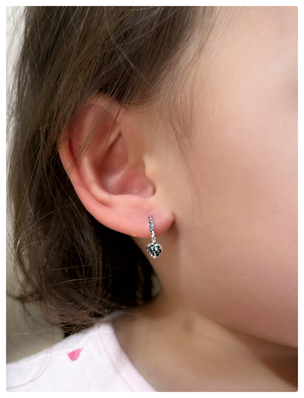 18K white gold earrings on a baby's ear