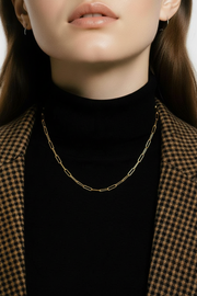 Model wearing the paper clip necklace on a black turtleneck. 