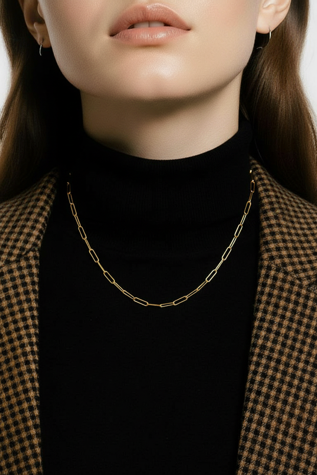 Model wearing the paper clip necklace on a black turtleneck. 