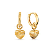 Pair of gold hoop earrings with a heart-shaped charm dangling from each hoop on a white background.