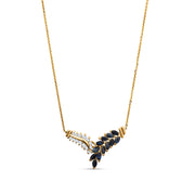 Gold feather necklace featuring white diamonds and vibrant blue sapphires on a white background.