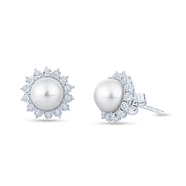 Pair of white pearl stud earrings surrounded by small diamonds on a white background.
