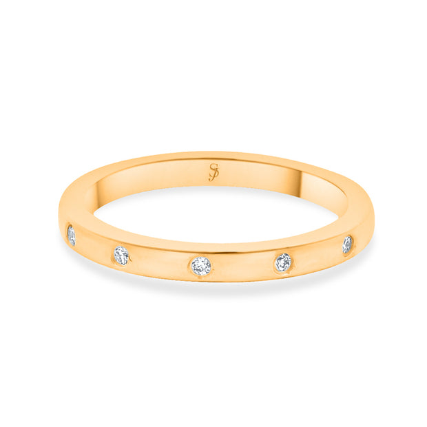 Gold diamond wedding band in a white background